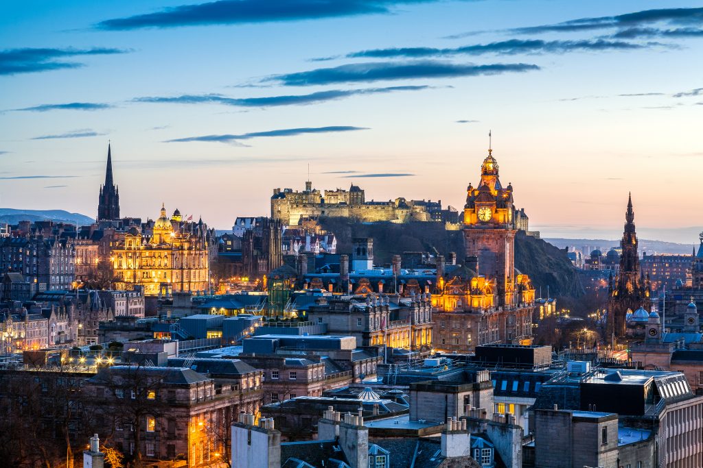 Skyline of Edinburgh at sunset with HDR processing. Cityscape include Edinburgh Castle, Balmoral Hotel Clock Tower and the Scott monument.